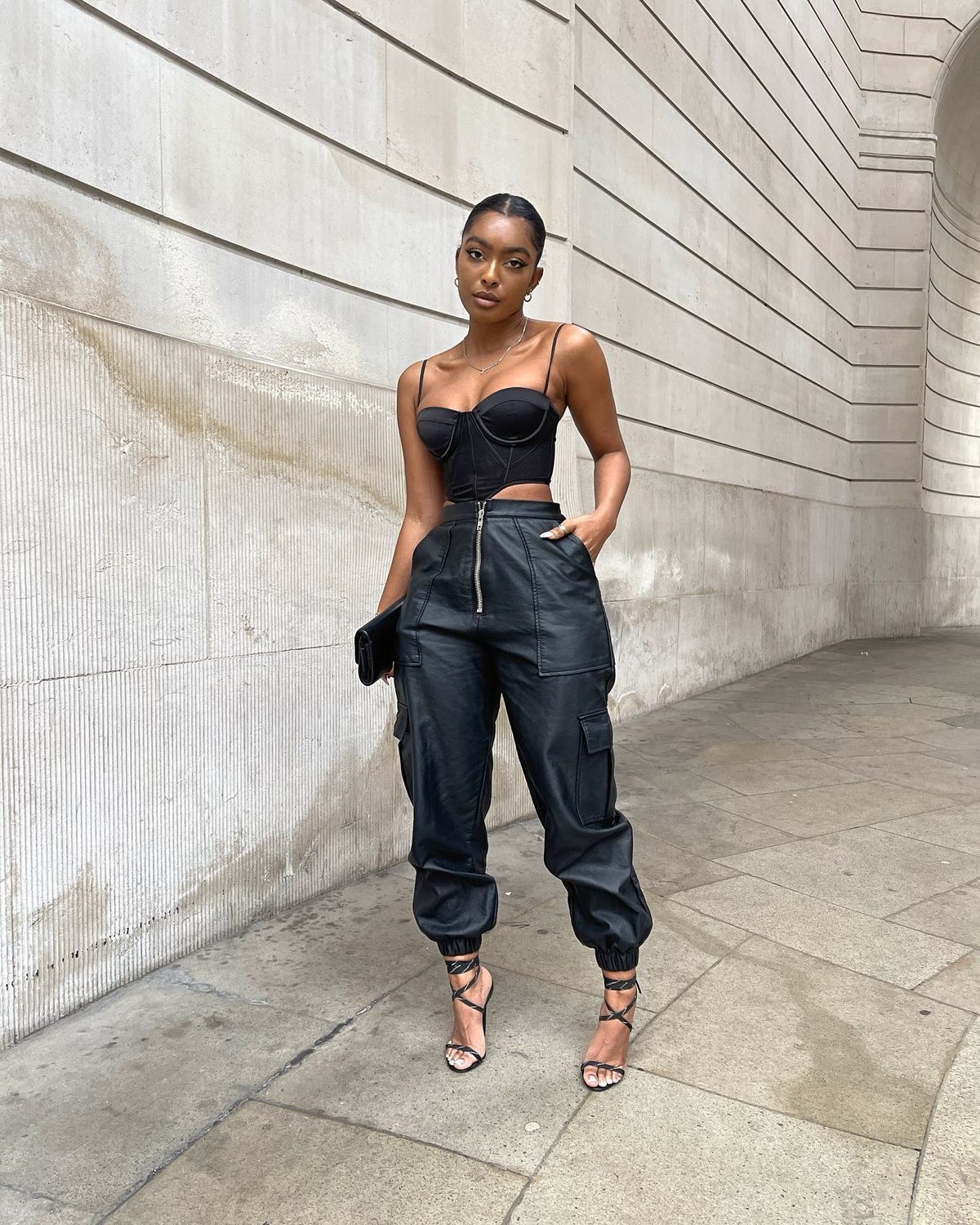 woman wearing corset with black cargo pants and sandals