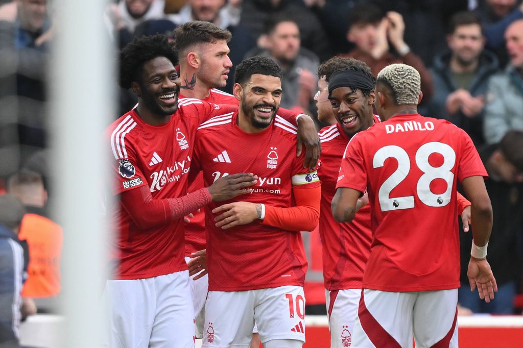 Morgan Gibbs-White celebrates with Ola Aina and Anthony Elanga following an own goal during the Premier League match between Nottingham Forest and Brighton and Hove Albion at the City Ground