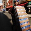 A delivery person transports soda in New York City during a summer heatwave.