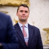 Charlie Kirk standing behind President Trump during a White House swearing-in ceremony on May 28.