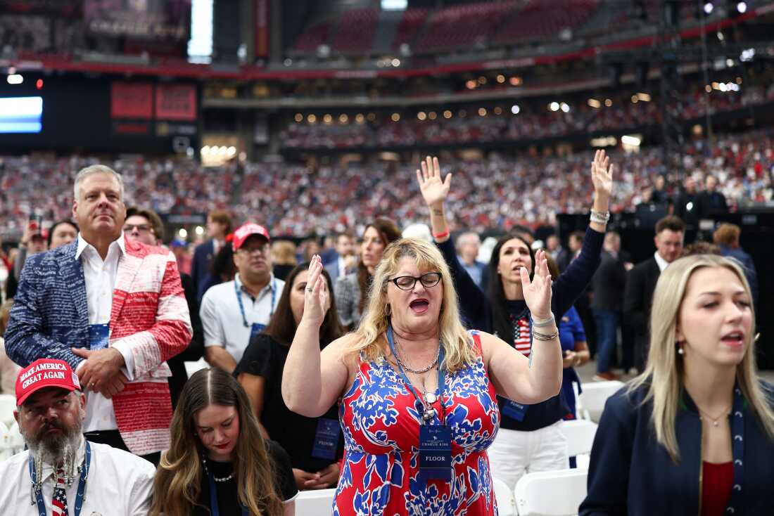 Attendees praying before Charlie Kirk's memorial service