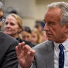 NIH Director Jayanta Bhattacharya and Health and Human Services Secretary Robert F. Kennedy Jr. speaking before a news conference, April 22.