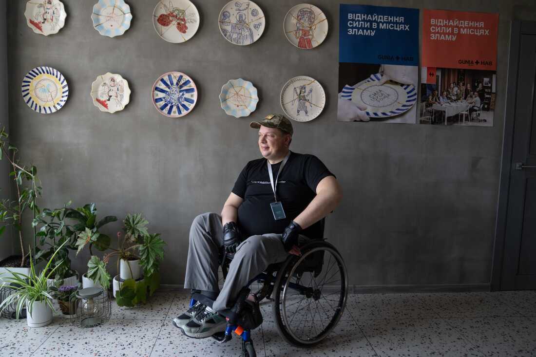 Serhiy Titarenko at the Lviv Habilitation Center, where he assists veterans in adapting to civilian life. The wall displays plates repaired using a Japanese technique symbolizing healing through acknowledging trauma.