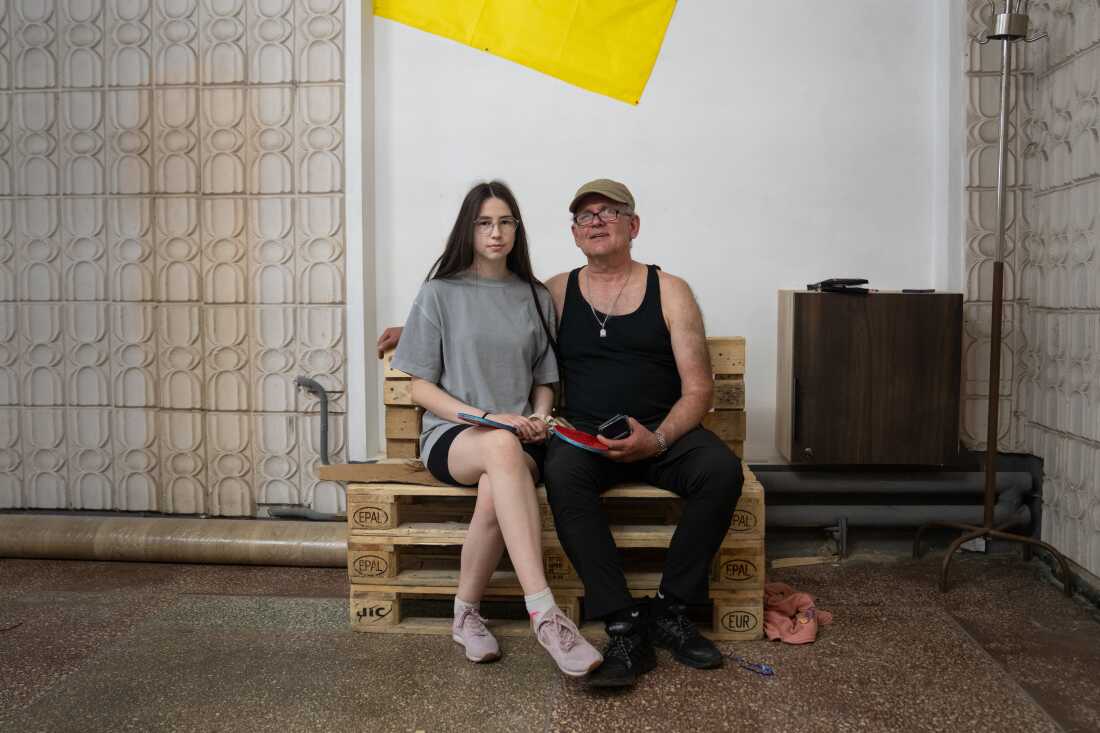 Arina Melnykov and her father Andriy share a moment after playing table tennis with other veterans.