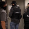 Immigration and Customs Enforcement officials stand outside immigration courtrooms while cases are being heard at 290 Broadway in New York.