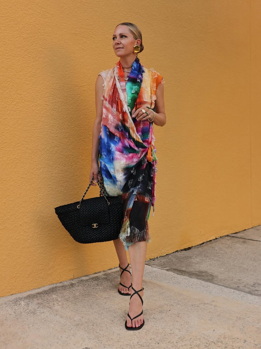 woman wearing multicolored dress with big bag and black sandals