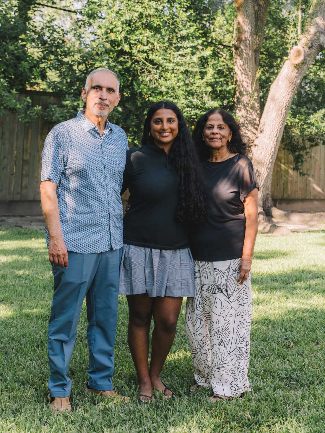 Avani Yaltho (center) with her grandparents Jacob and Molly George in their Houston backyard.
