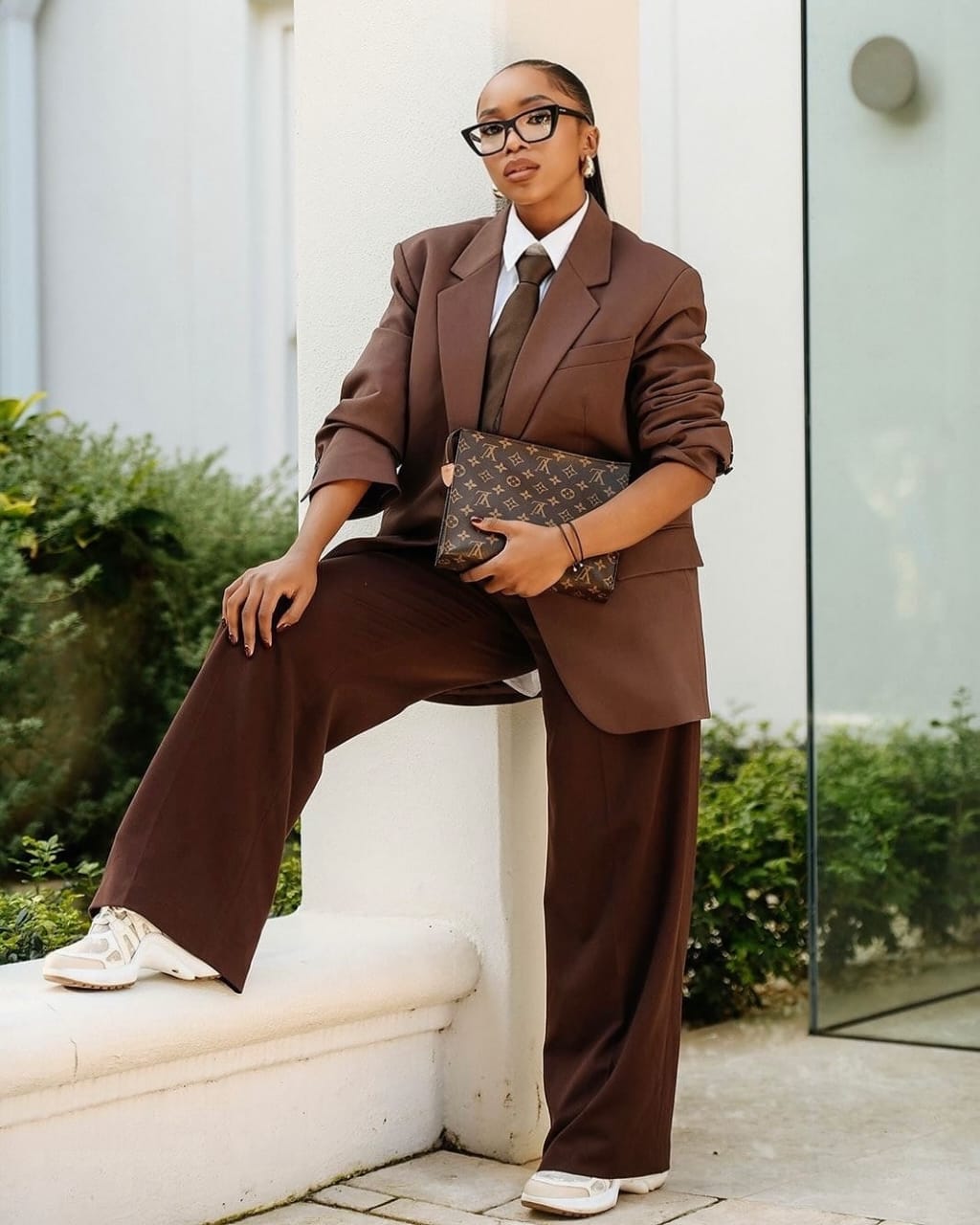 woman wearing a brown suit with matching <a href=