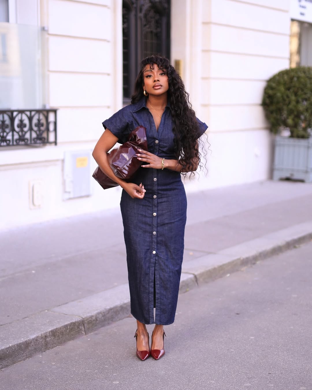 woman wearing denim dress with leather tote bag