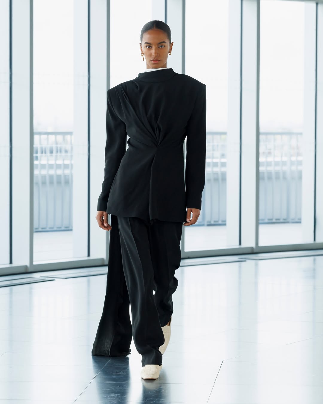 woman wearing black suit from tove