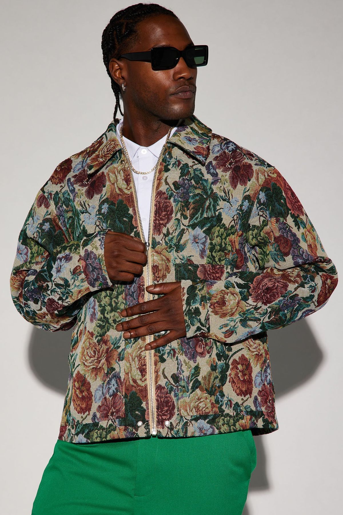 man wearing floral chore jacket with green pants
