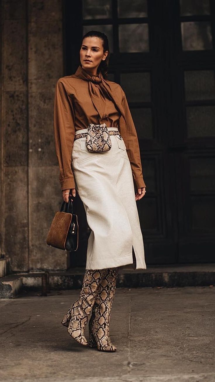 woman wearing satin top with cotton skirt and snakeskin boots