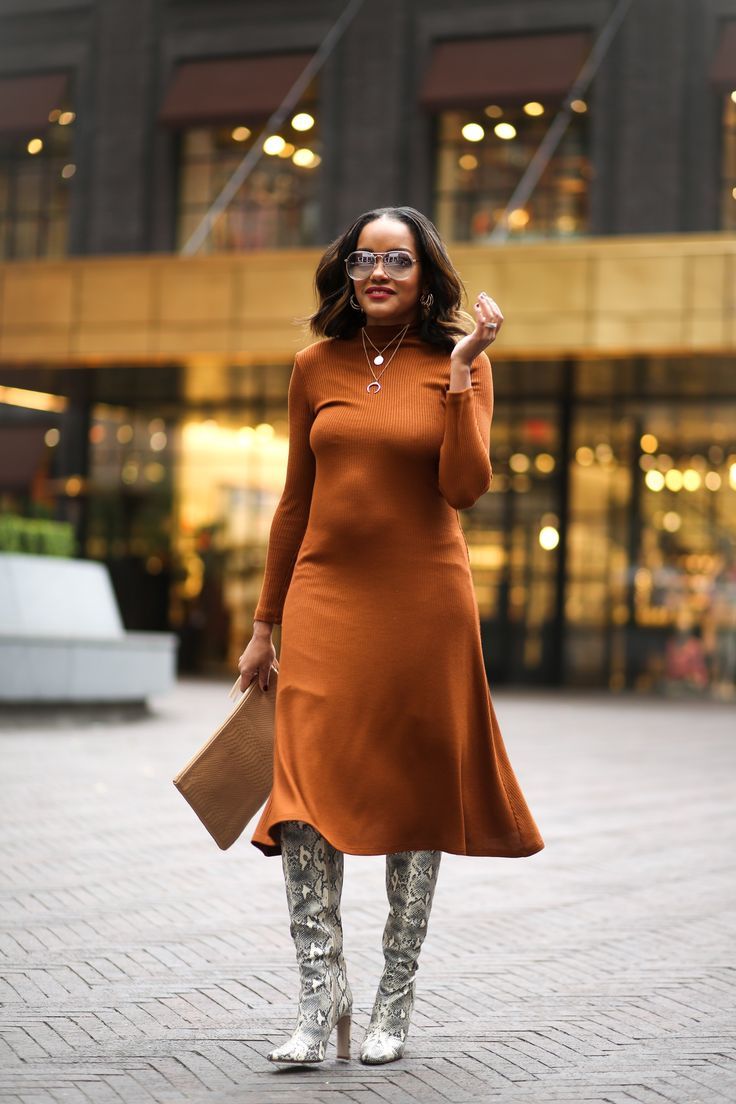 woman wearing brown midi dress with snakeskin boots