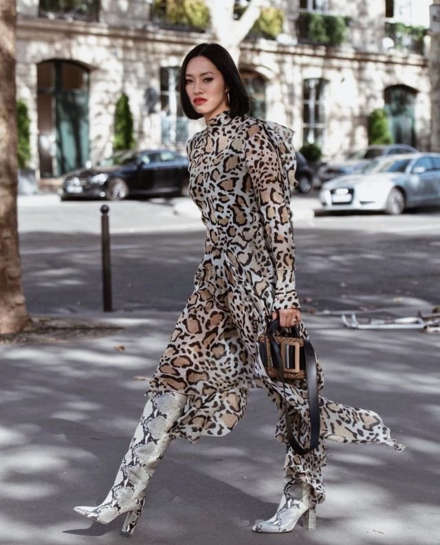 woman wearing mixed patterns with snakeskin boots