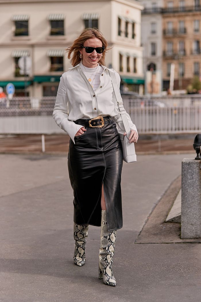 woman wearing pencil skirt with white top and snakeskin boots