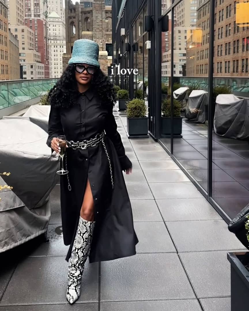 woman wearing statement accessories with snakeskin boots