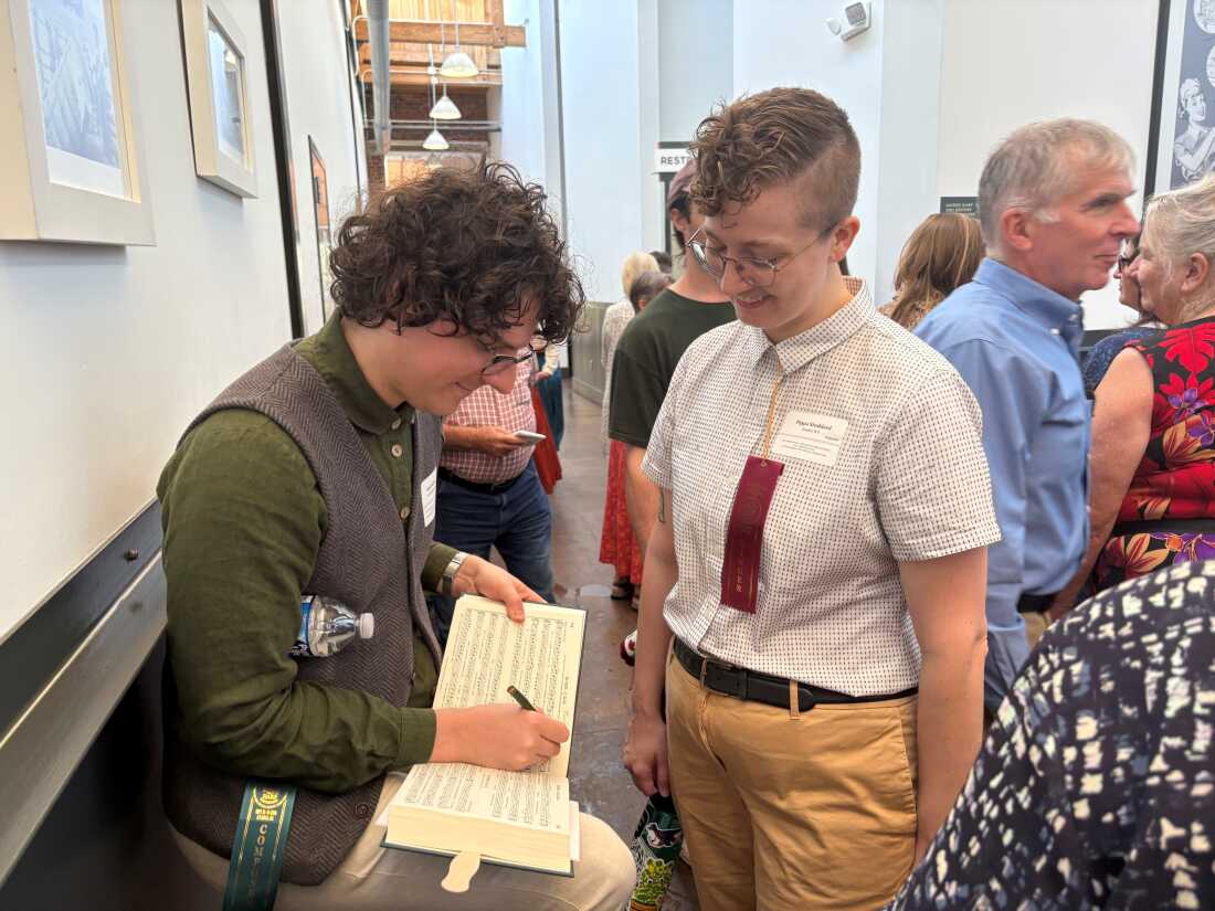Micah Walter signing his composition 'Revere' for a fellow singer.