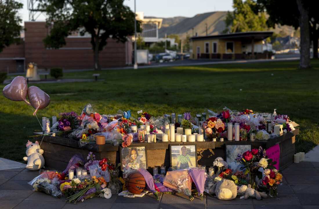 FILE - Memorial with pictures, flowers, and candles honoring Olivia, Paityn, and Evelyn Decker in Wenatchee, Wash.