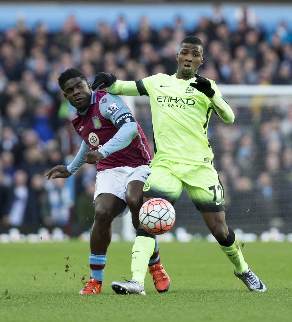 Aston Villa vs Manchester City. Kelechi Iheanacho comes in hard on defender Micah Richards for the ball