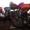 Palestinian children and families receiving hot meals from charity organizations.