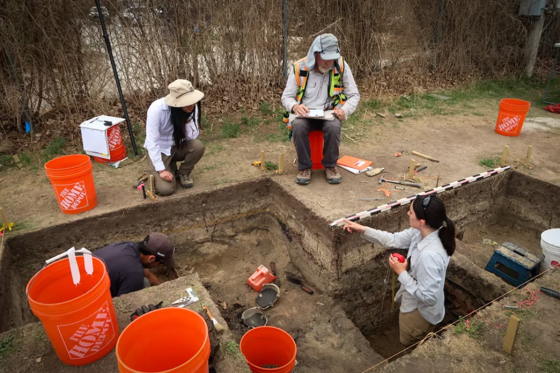 Grinnell College students Jorge Salinas and Julia Ghorai are several feet deep in the trenches of the Rock Springs dig site. Professor Laura Ng and assisting archaeologist Paul Hoornbeek advise from above.