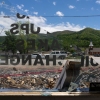 A view of Swannanoa, in western North Carolina, through the broken window of Harper's Automotive on U.S. Highway 70. The shop was heavily damaged by the storm last September.