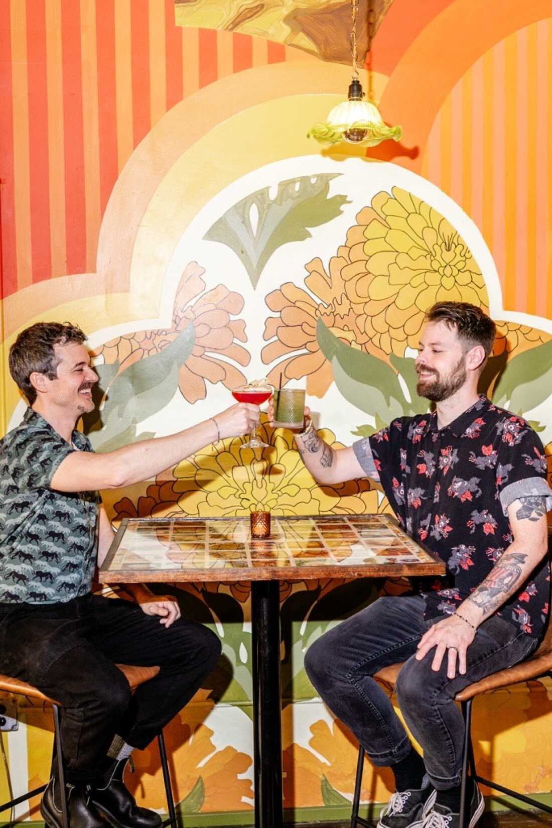 Brandon Davis and his husband Davie at the new Day Trip bar location after the original was destroyed by Hurricane Helene.