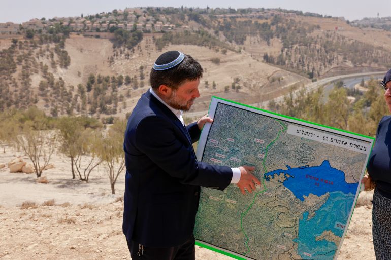 Israeli far-right Finance Minister Bezalel Smotrich holds a map near the settlement of Maale Adumim in the occupied West Bank