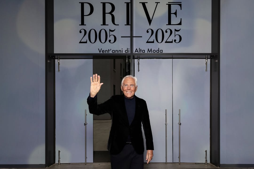 Giorgio Armani at a fashion show, showcasing his timeless tailoring style.