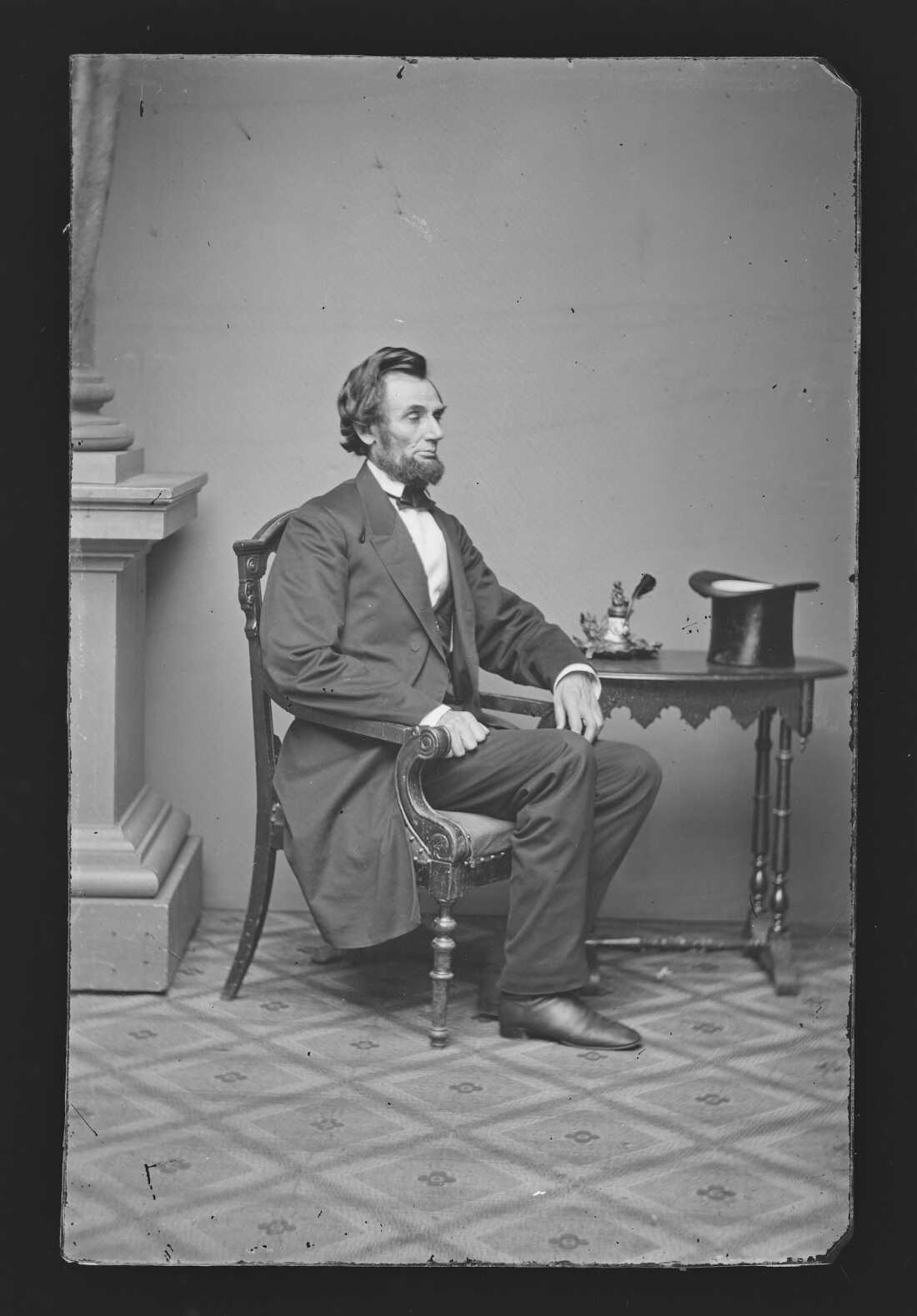 Photograph of President-elect Abraham Lincoln in his iconic black frock coat, waistcoat, trousers, and narrow cravat, taken shortly before his inauguration.