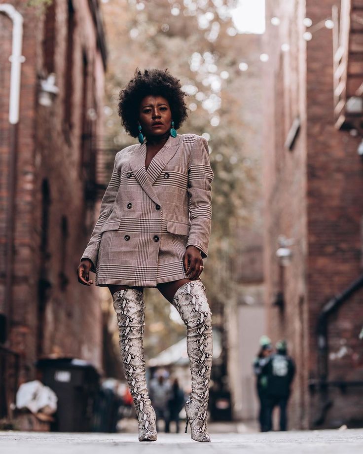 woman wearing mini blazer dress with thigh-high snakeskin boots