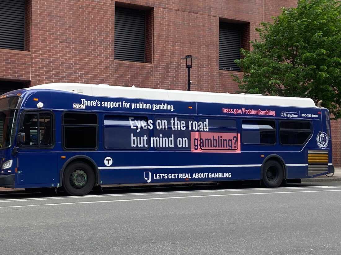 Boston bus featuring a public service announcement promoting responsible gambling.