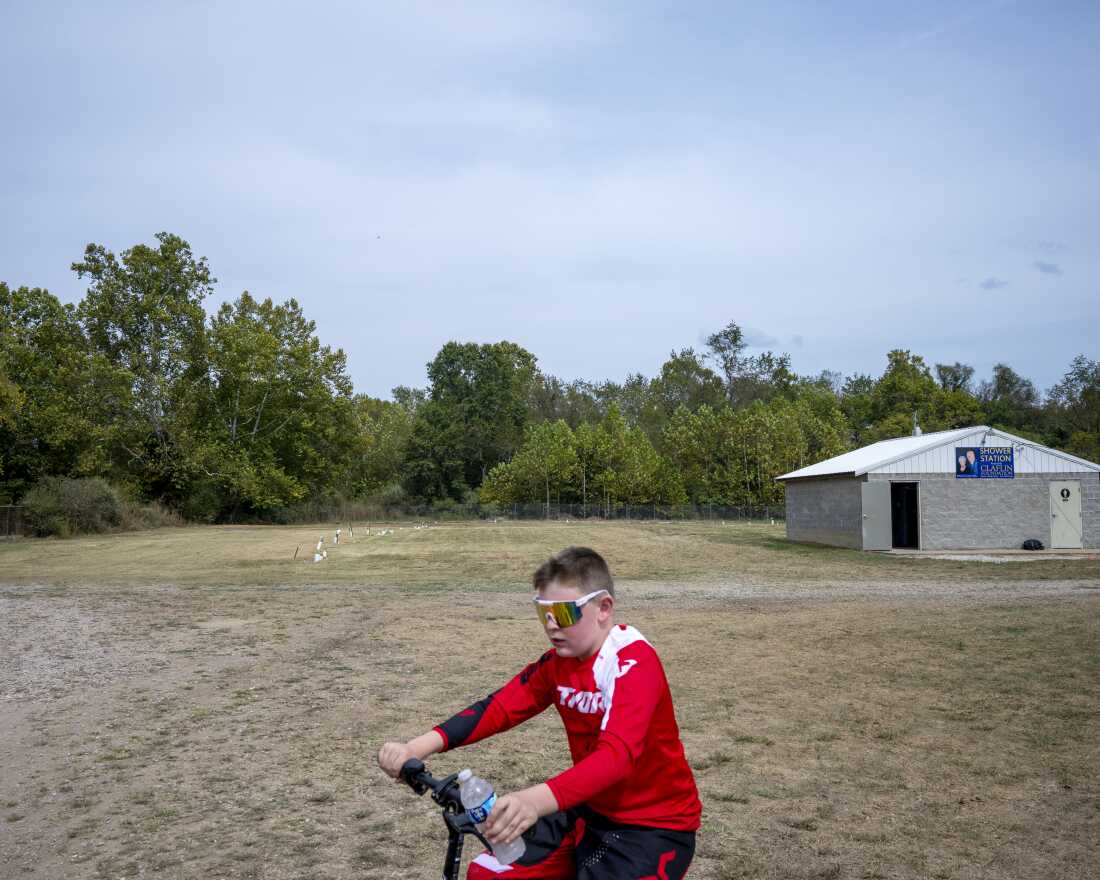 Mason Freeman, 12, rides past the empty field where the Mothman was first spotted in Point Pleasant, W.Va.