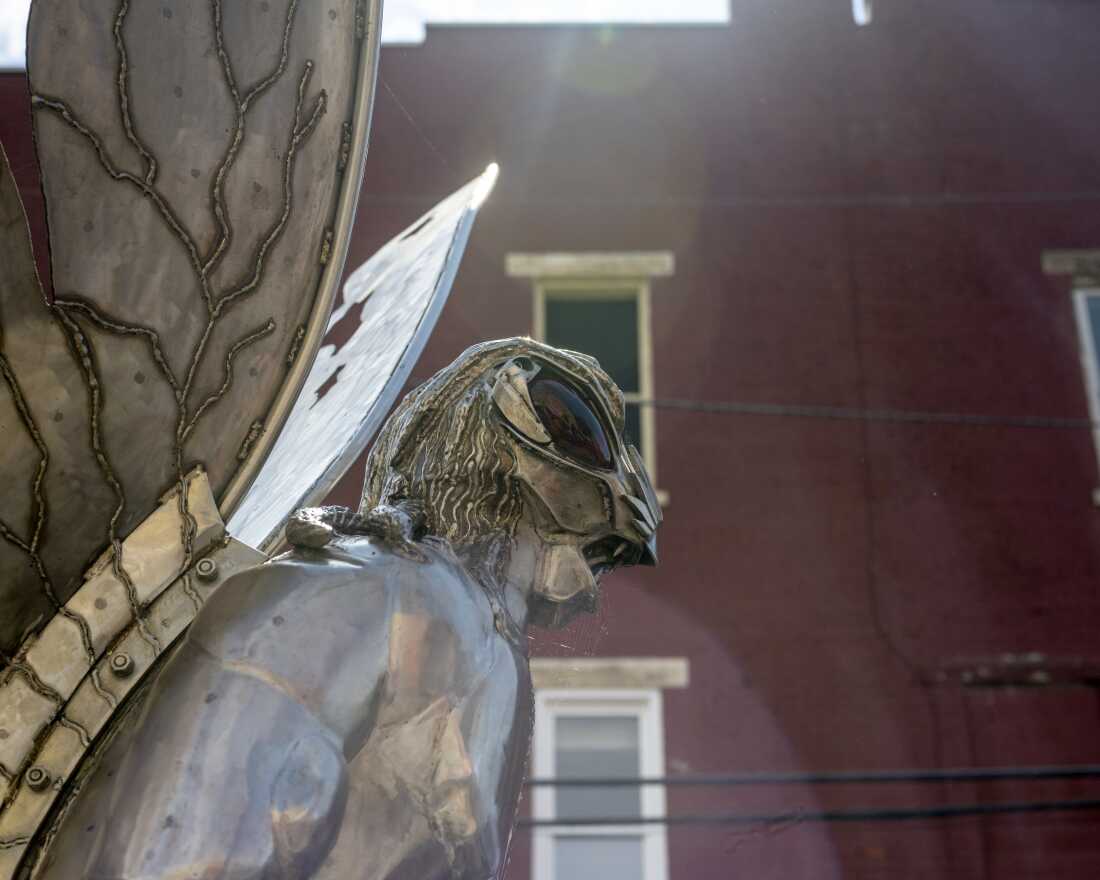 A profile shot of the upper body of a 12-foot stainless steel sculpture of Mothman created by artist Bob Roach.