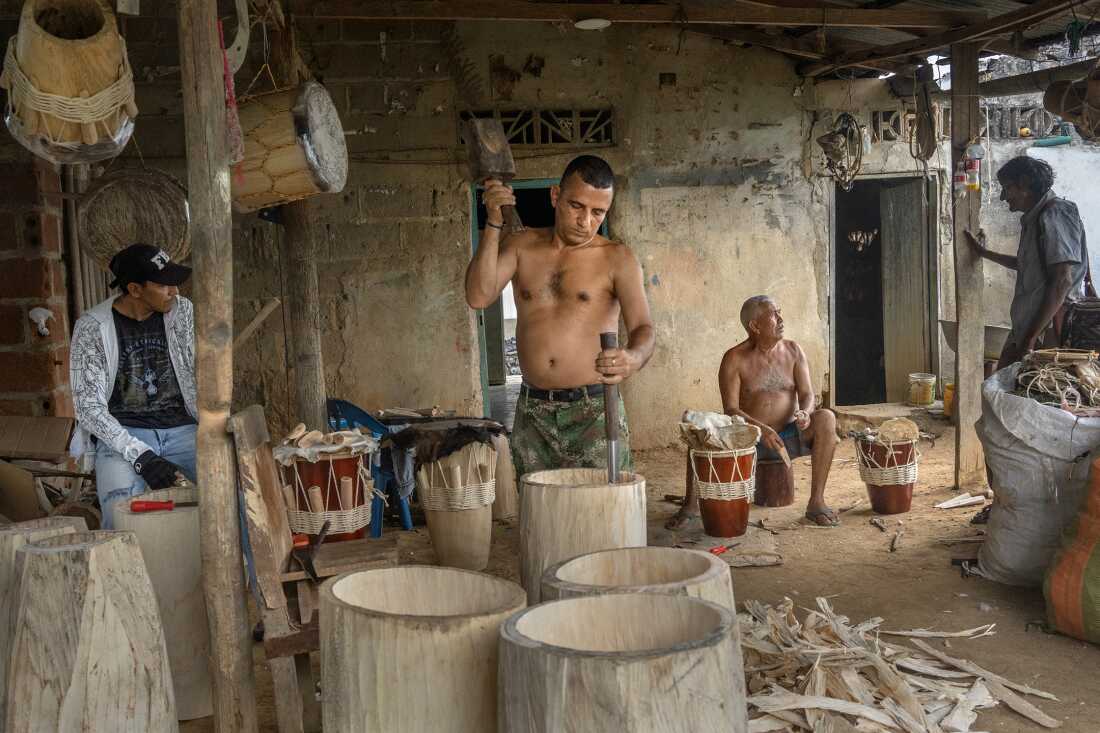 Carlos Casas Serrano crafts a tambor alegre, a traditional cumbia drum, in Colilo Lara's workshop on August 12, 2022, in San Jacinto, Bolívar, Colombia, during the Festival Nacional Autóctono de Gaitas. Colilo, son of one of the original Gaiteros de San Jacinto, has been making drums for over fifty years. The gaita, a traditional instrument made from <a href=