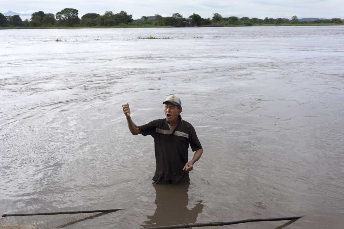 José Benito Africano Mendoza performs cumbias for people gathered along the Magdalena River in El Banco, Magdalena, Colombia, on August 7, 2022. Africano composes and sings cumbias, including 