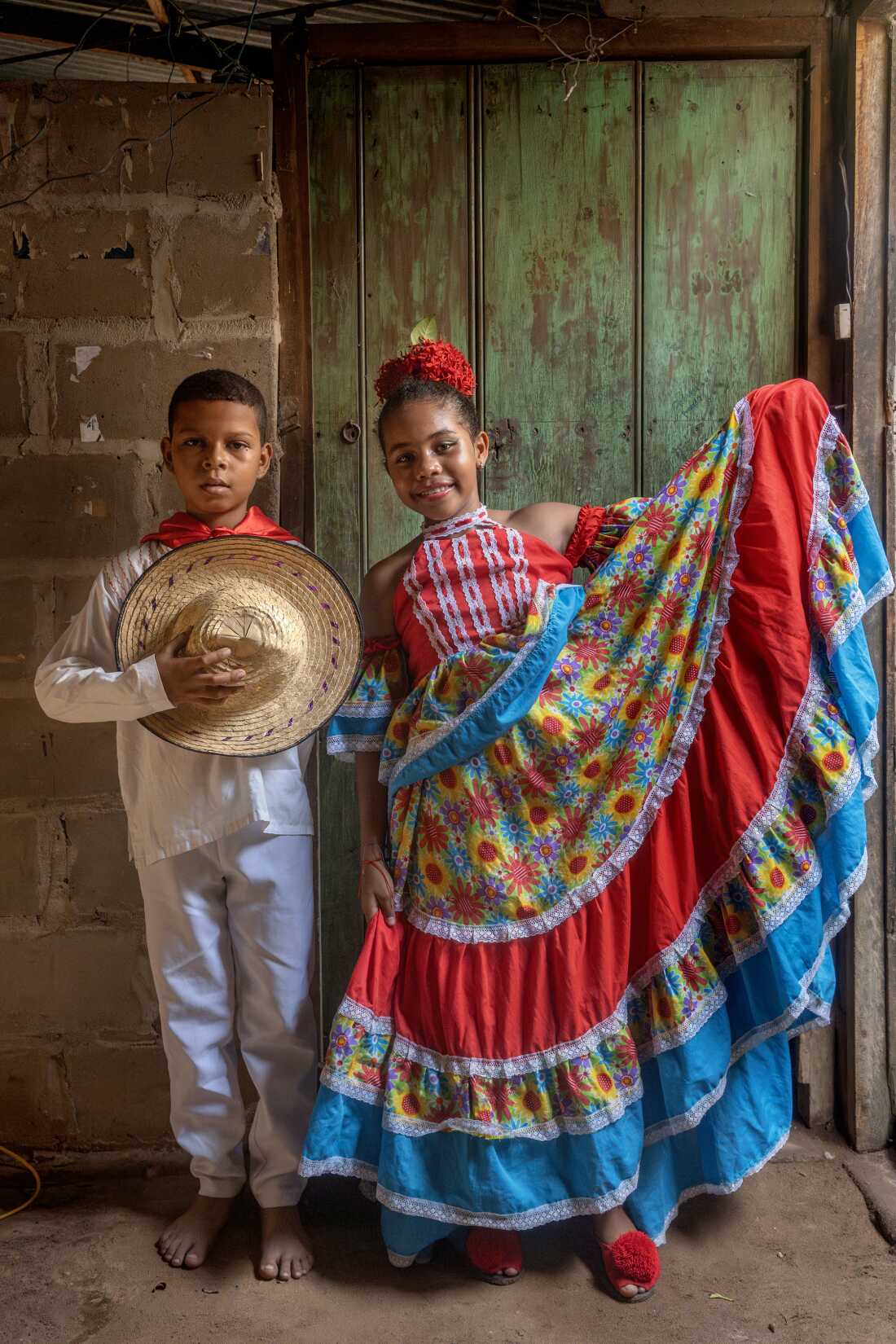 Yojan David Laguna Ospino and Jakelin Guillen Epalza, both 11, from the dance troupe Costa Azul Danza Indio Manzos, pose in Playa Blanca, Guamal, near El Banco, Magdalena, Colombia, on August 6, 2022.