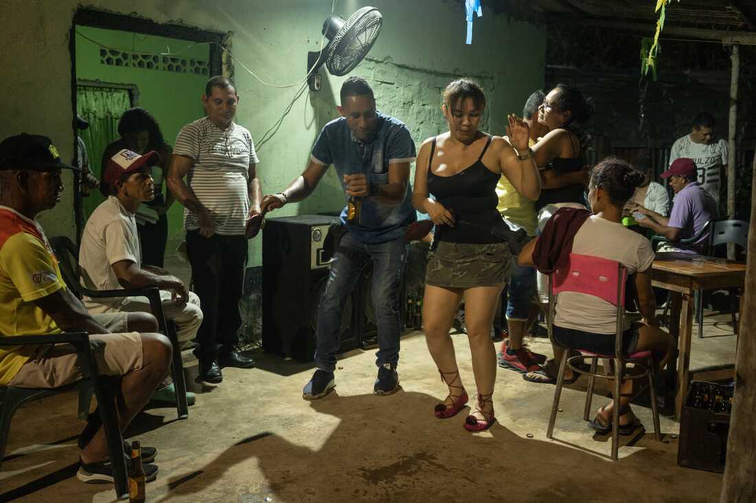 A lively celebration in the El Cesar neighborhood of El Banco, Colombia, on August 7, 2022, coinciding with the inauguration of Colombia's new president. Residents gathered to dance cumbia in front of the dock, reflecting the deep cultural ties to the music. El Banco and its surroundings along the Magdalena River are widely regarded as the birthplace of cumbia. The National Festival of Cumbia, held in El Banco Magdalena, was founded in 1968 in honor of composer José Benito Barros Palomino.