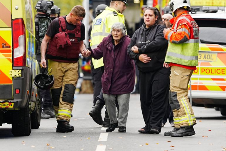 An elderly woman assisted away from the scene of the stabbing at Heaton Park Hebrew Congregation Synagogue in Manchester.