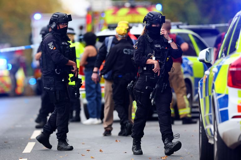 Armed police officers stand guard near Heaton Park Hebrew Congregation Synagogue in Manchester following the attack.