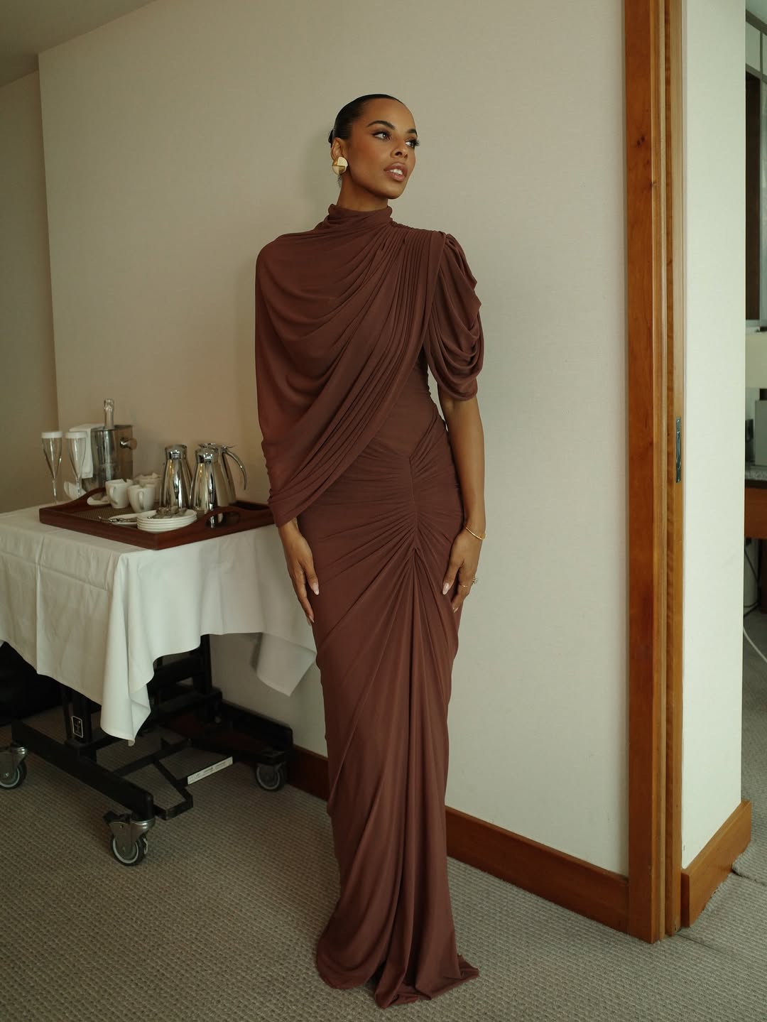 woman wearing draped maxi brown dress