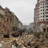 People walk near apartment buildings damaged after a Russian attack in Kyiv.