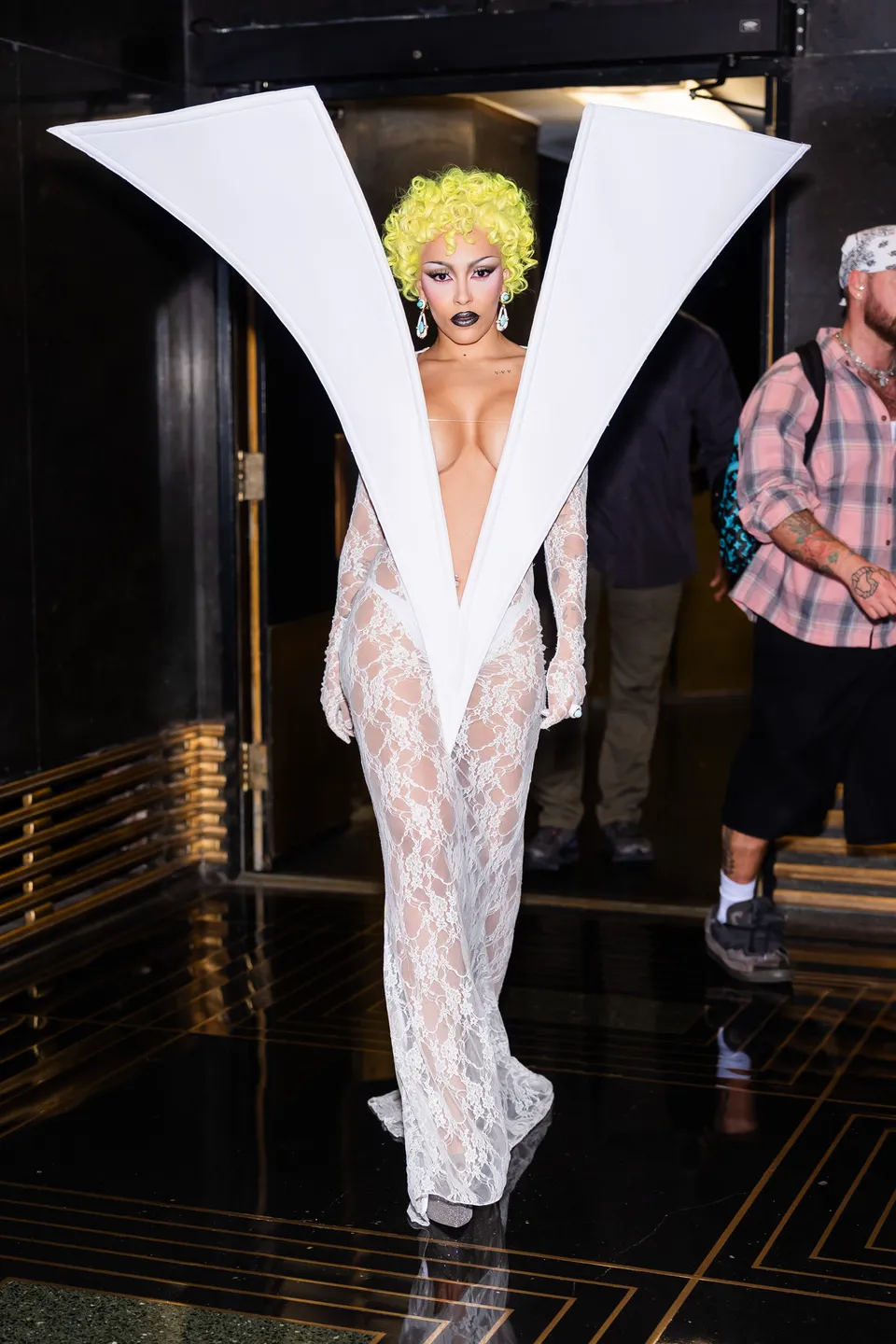 Doja Cat turns heads in a daring white lace gown by Quine Li while arriving at NBC Studios for SNL.