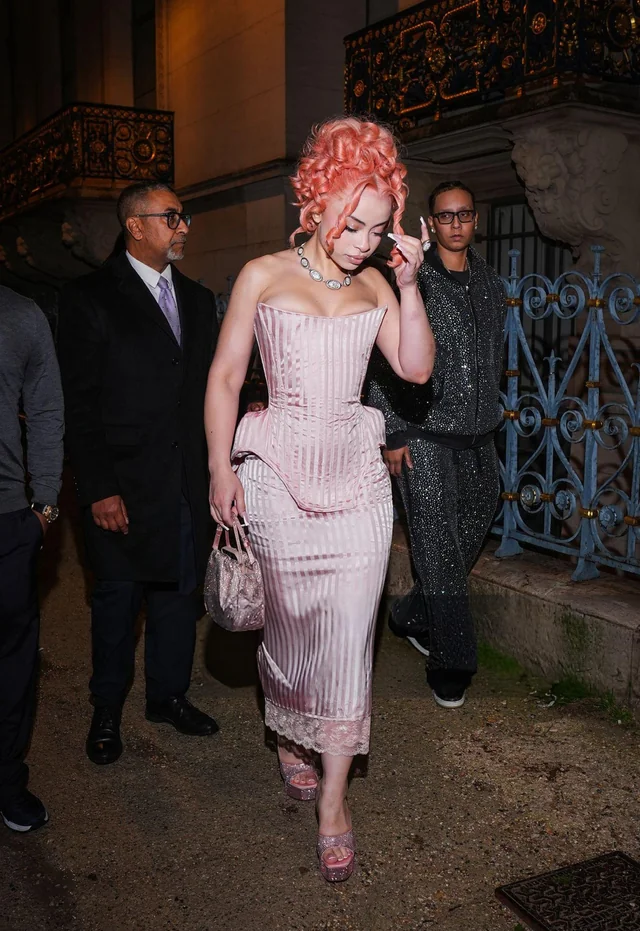 Ice Spice poses in a chic ensemble with signature curls shared on Instagram.