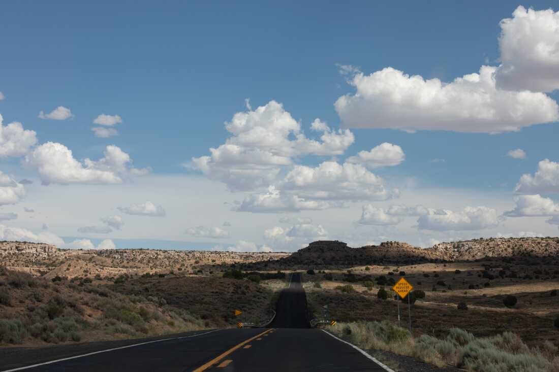 Blue sky with clouds over a winding road on the Hopi Reservation