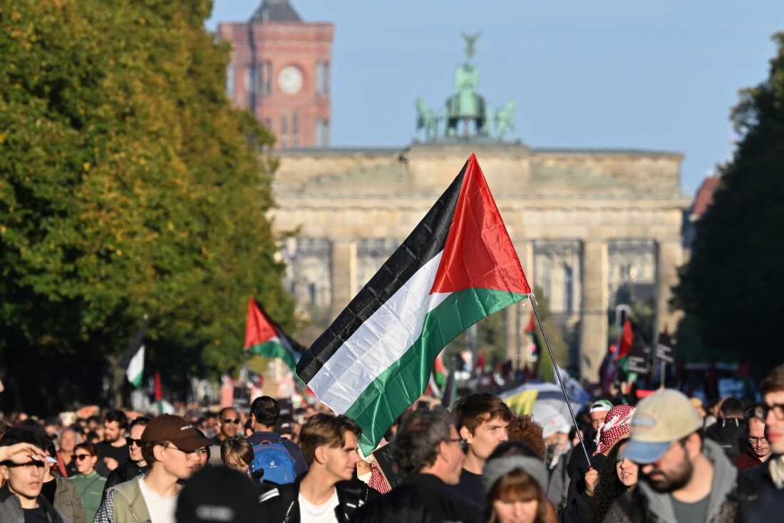 Demonstrators carrying Palestinian flags march near the Brandenburg Gate in Berlin on Sept. 27, demanding Israel halt its military campaign in Gaza.
