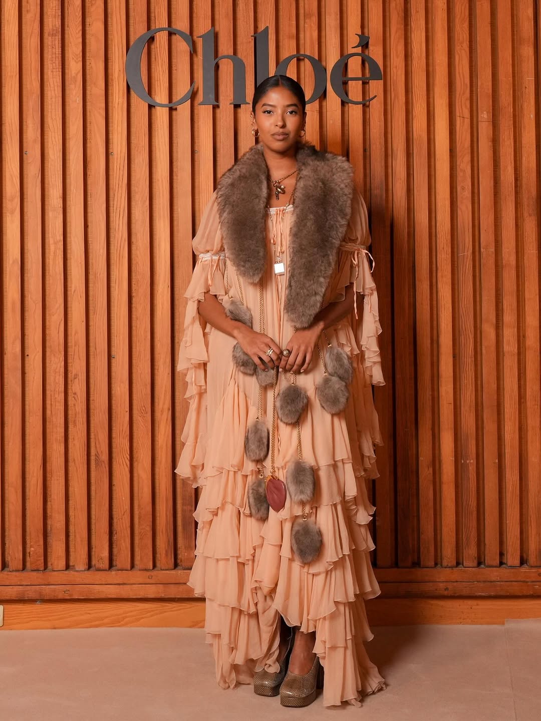 woman wearing tiered maxi dress with fur trim