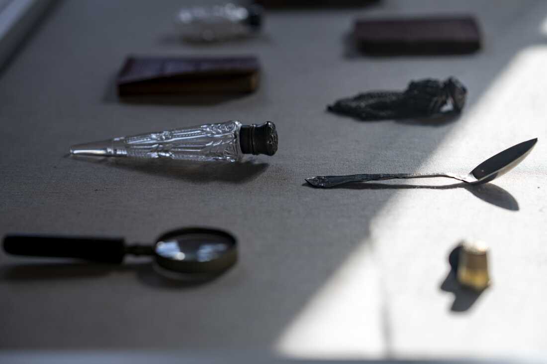 Display case with belongings of African American tenement residents, including a spoon and Lincoln speeches.