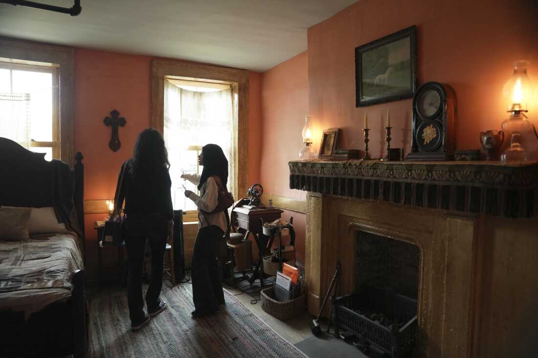Students explore the recreated bedroom of Rachel and Joseph Moore at the Tenement Museum.