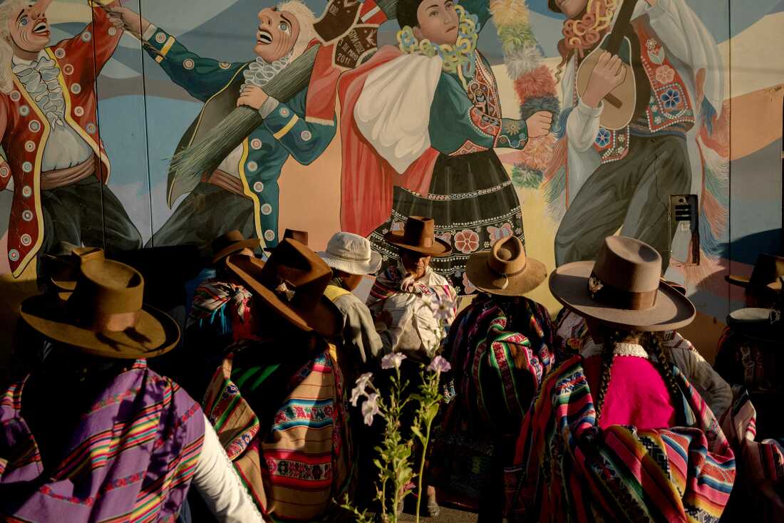 Women gathering after the 137th anniversary celebration of Sicuani, Peru, on November 4, 2024. The indigenous clothing colors inspired the vibrant chicha art posters promoting cumbia concerts. ArmonÃa 10, a cumbia orchestra founded in 1972, performed that evening.